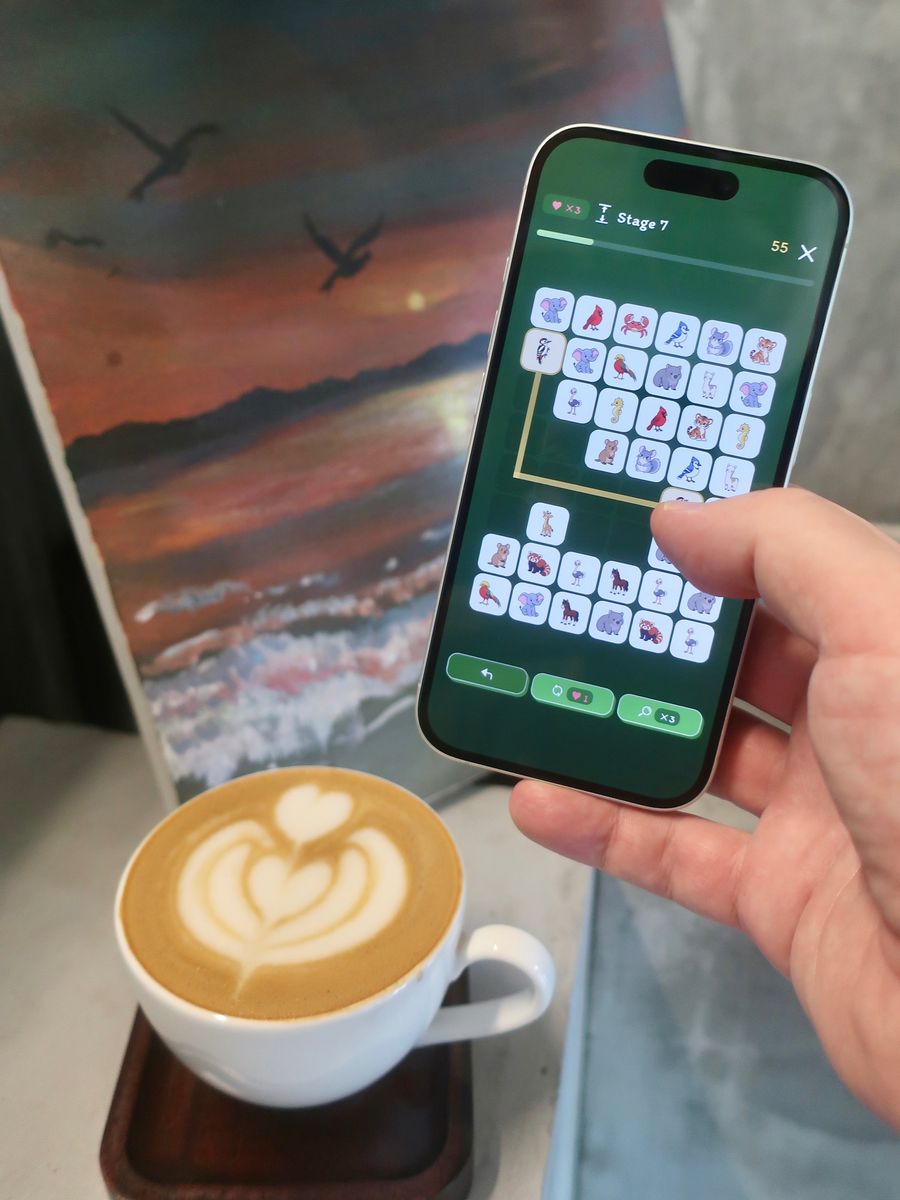 Linking a pair around the edge of an animal board, with latte art in the foreground.